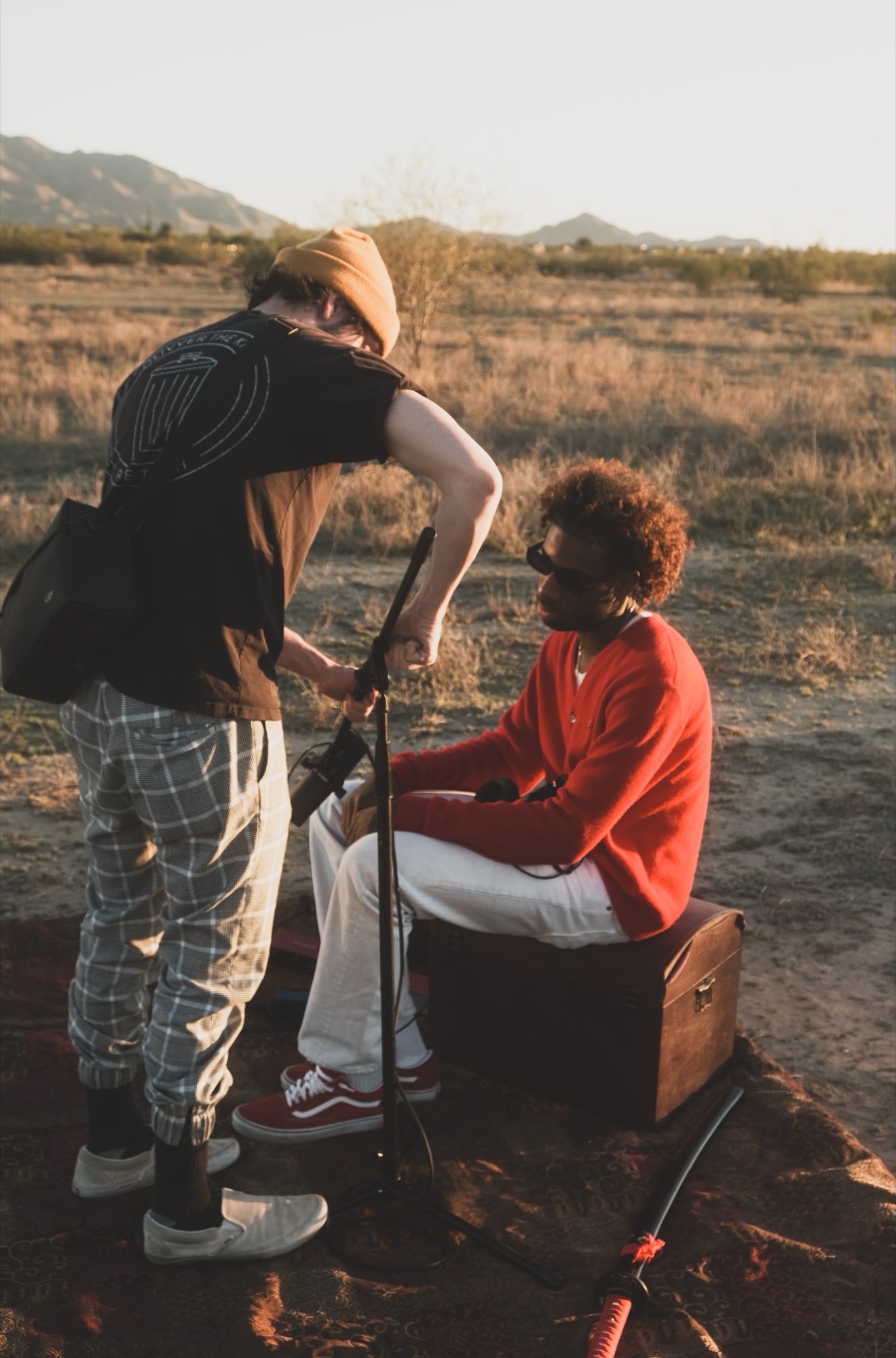 Xavier Cicero setting up a microphone on location in the desert
